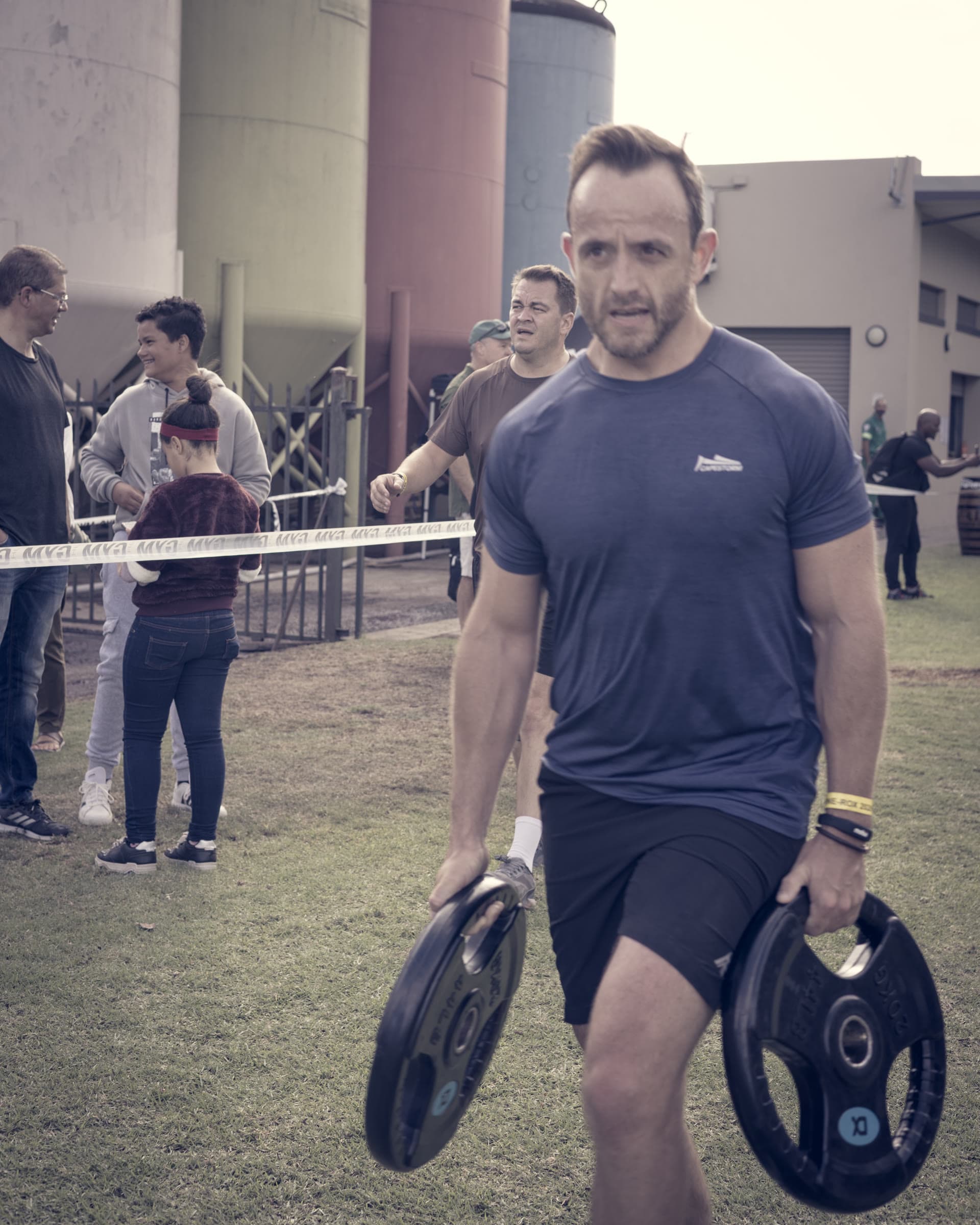 Athlete carrying weight plates at the Wine-Rox event